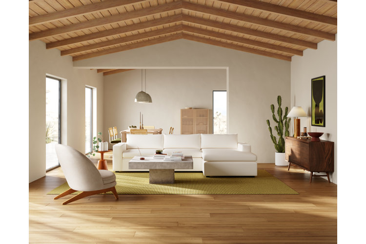 organic modern living room with a neutral color scheme, light wooden floors and paneled ceiling, white upholstery, and a green area rug