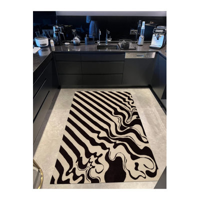 Tapis noir tissé à motif abstrait noir et beige