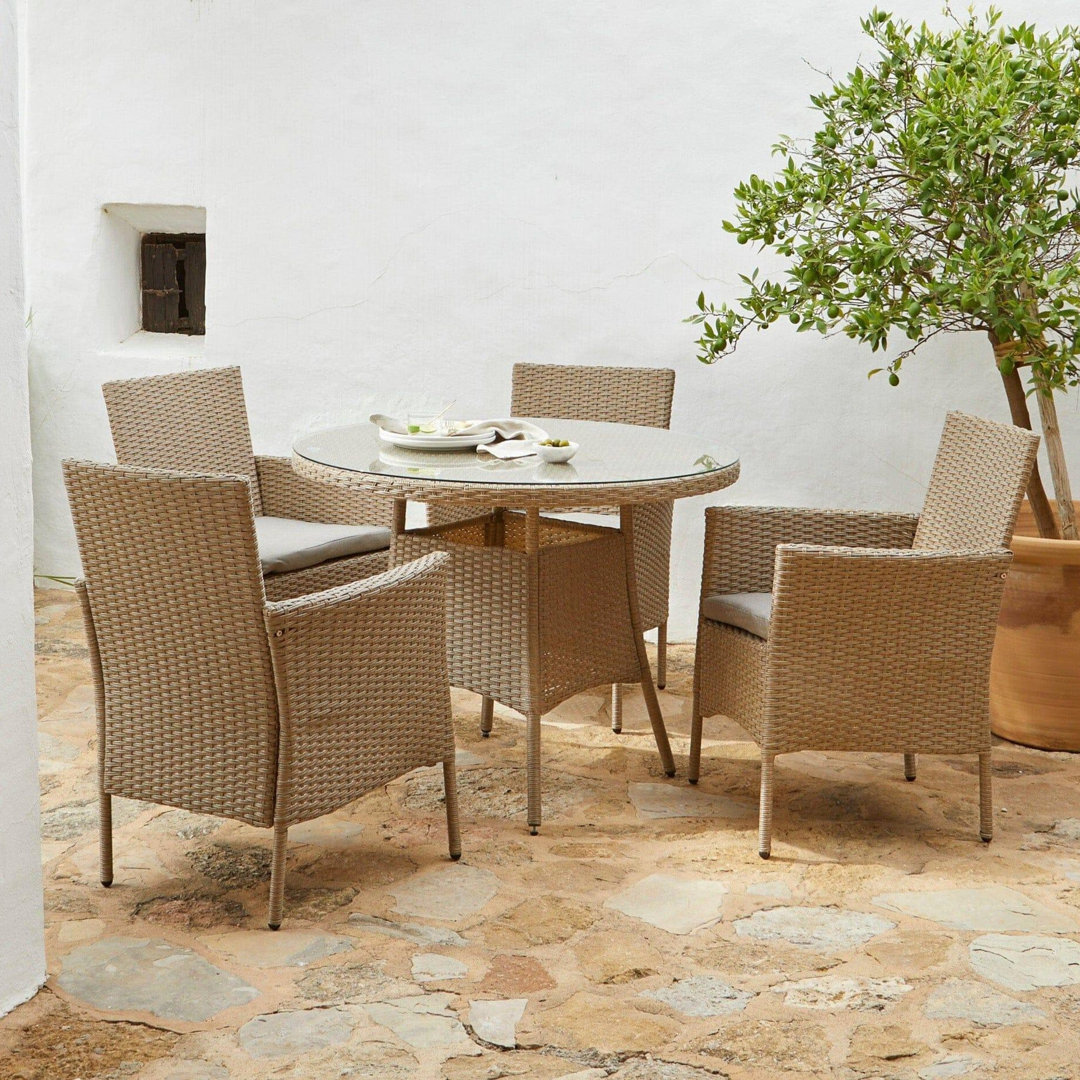 Dubose 4 - Person Wicker Patio Dining Set with Round Table , Cushions Included