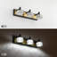 Luminaire de salle de bain moderne à DEL à intensité variable avec appliques en cristal, finition noire et dorée, éclairage mural écoénergétique au-dessus d'un miroir