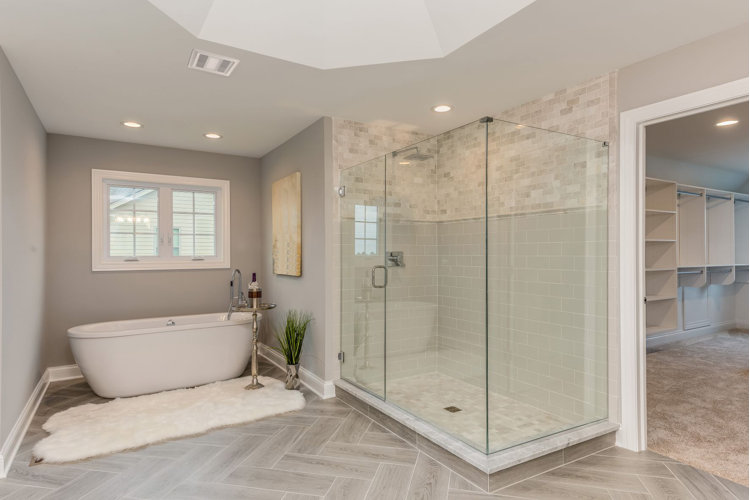 modern bathroom with freestanding tub, double vanity, and a glass-enclosed shower