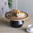 12" Round Wooden Pedestal Tray with Sculptural Iron Stand, Decorative Display Riser with Black Accents for Tabletop, Kitchen & Home Décor