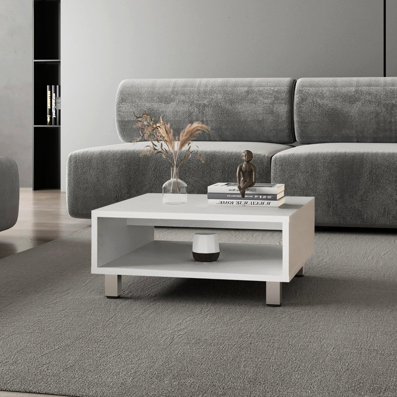 Table basse blanche avec un grand espace de rangement ouvert - Le revêtement résiste aux égratignures et convient aux espaces loft.