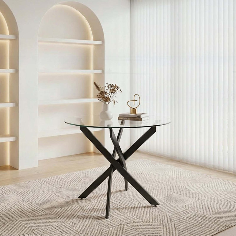 Table de salle à manger ronde en verre avec pieds noirs, design minimaliste moderne pour des espaces compacts et une salle à manger élégante
