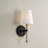 6" W x 14.25" H 1-Light Wallchiere Sconce in Matte Black with Textured Hammered Gold Tail and White Fabric Shade