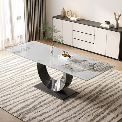 This Extendable Dining Table Made Of Synthetic Sintered Stone Extends From 63'‘ To 94.5’' And Seats 8–10 People. It Comes With A Stainless Steel Base.