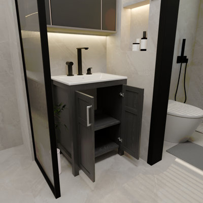 Une armoire de salle de bain de 24 pouces, jumelée à un lavabo en céramique, présente un design moderne et est faite de matériaux imperméables et durables.