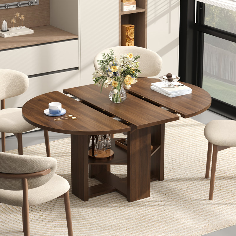 Table de salle à manger extensible ronde à ovale de 109 à 150 cm de large pour 4 à 6 personnes, avec rangement dissimulé et piètement en croix, style ferme moderne.