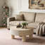 Table basse ronde avec plateau rabattable et compartiment de rangement caché