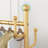 Modern Golden Metal Bracket - Elegant Storage Hanger with Rollers and Storage Baskets