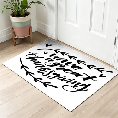 Tapis intérieur orange lavable à la machine, motif Thanksgiving, avec lettrage dessiné.