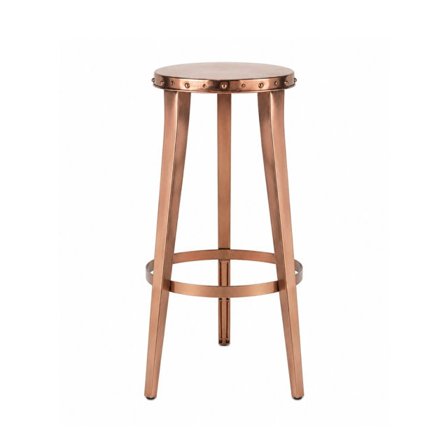 Copper metal bar stool with a round seat featuring decorative stud detailing and a circular footrest.