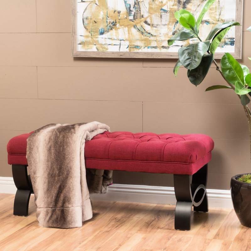 Élégant banc en tissu rouge avec un capitonnage exquis et un revêtement lisse d'un design élégant
