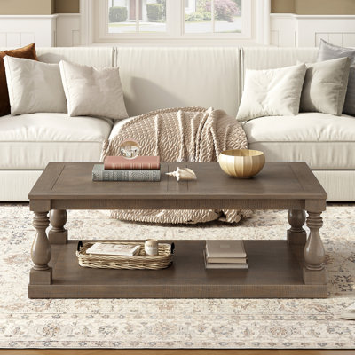 Coffee Table Featuring Artistic Vase Column Legs