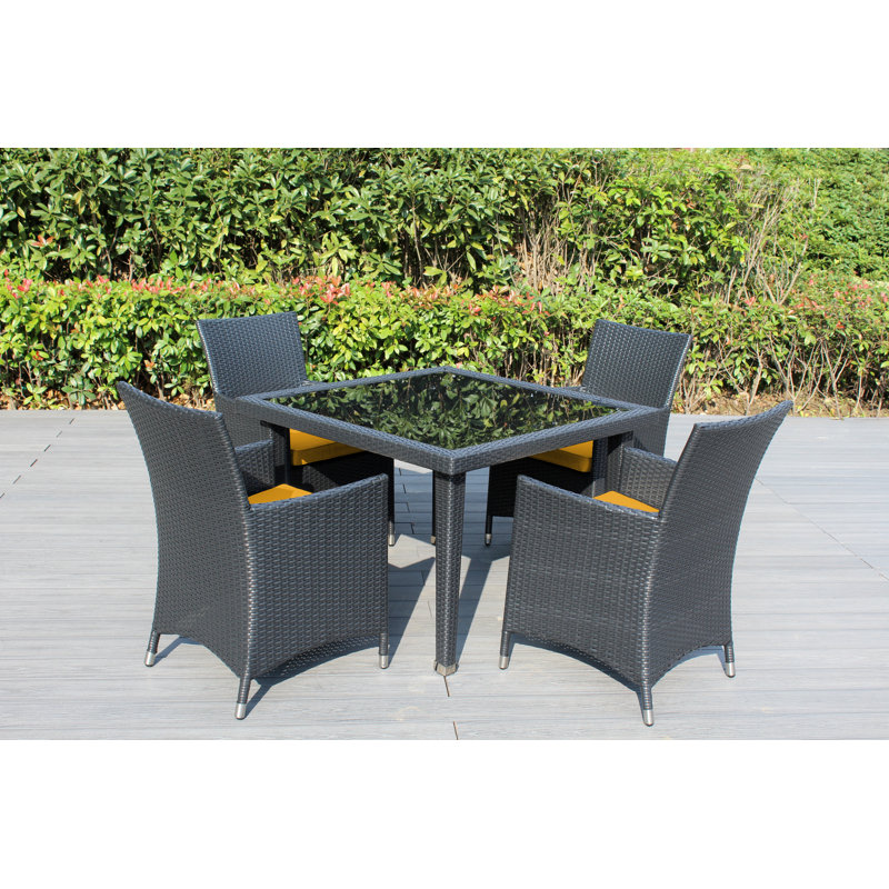Lumini 4 - Person Wicker Patio Dining Set with Square Table , Cushions Included, Canvas Sunflower Yellow Sunbrella® Canvas