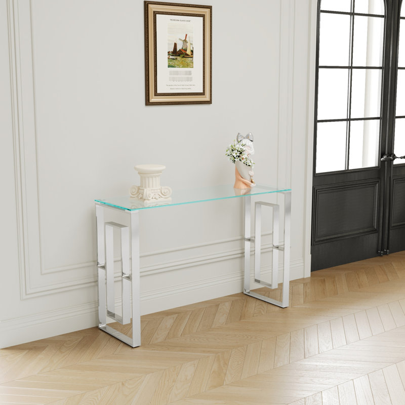 Console avec pieds en acier inoxydable et plateau en verre - Design moderne pour espace de vie et transparence