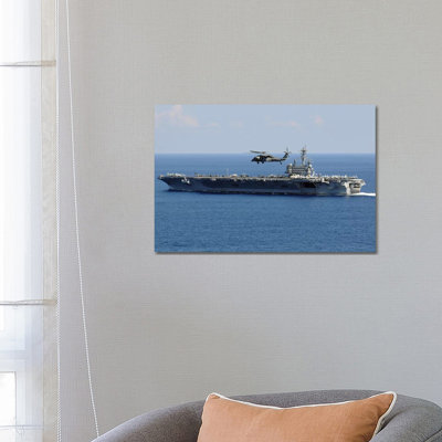 An MH-60S Seahawk Helicopter Flies Over USS George H.W. Bush by Stocktrek Images - Wrapped Canvas Print