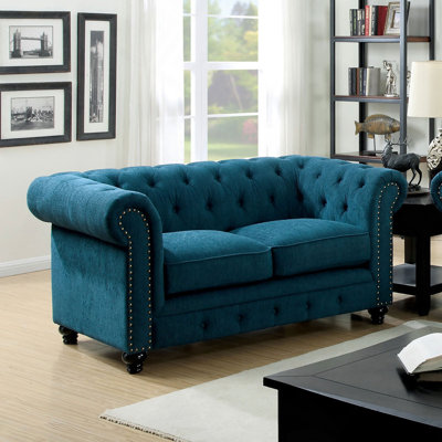 Causeuse contemporaine capitonnée de couleur bleu sarcelle à boutons capitonnés et capitonnée