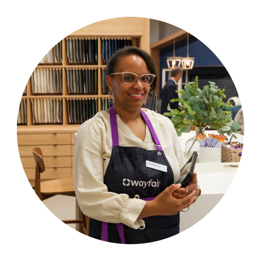 Xiomara A, Wayfair employee in apron holding tablet