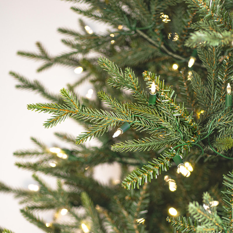 Vickerman 9.5' x 60" Slim Itasca Fraser Fir Artificial Pre-Lit Christmas Tree with 1050 Warm White LED Mini Lights, 3076 Realistic PE/PVC Tips, 6' Step On/Off Power Cord and Folding Metal Tree Stand. Assembly is required.