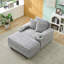 Canapé simple en velours côtelé gris avec un coussin, deux coussins décoratifs, un repose-pieds et deux espaces de rangement.