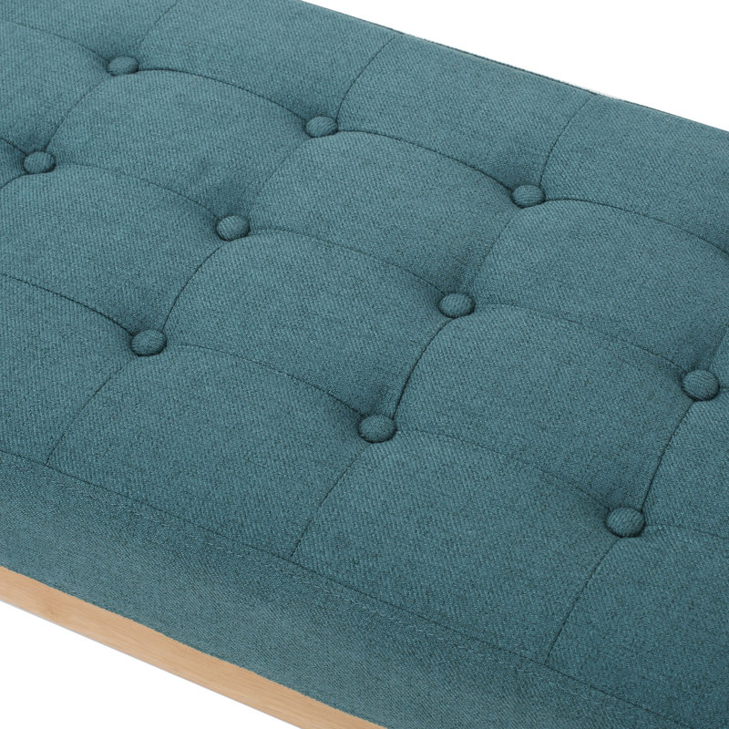 Élégant banc bleu sarcelle, revêtu d'un tissu de qualité et d'une structure texturée en bois de bouleau