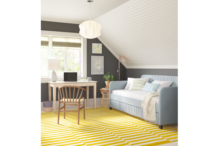 Small bedroom home office combo with a yellow striped area rug.