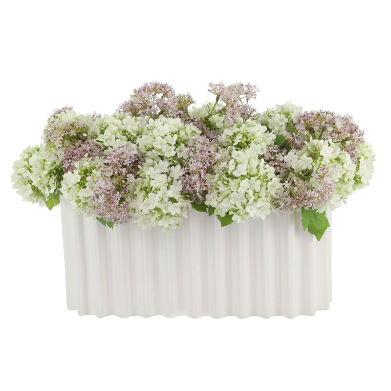 Viburnum and Weeping Laurel Arranged in a Ceramic Vase
