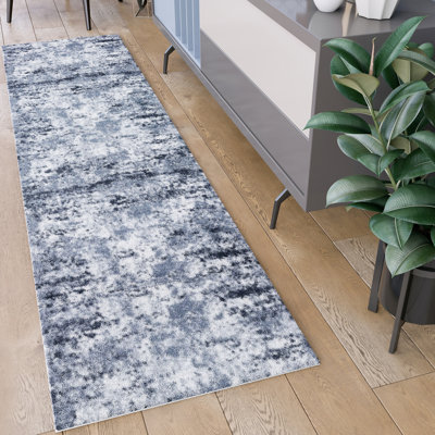 Tapis bleu clair à motif abstrait Baez