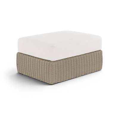 Table basse / repose-pieds de patio en tissu et osier Delmos