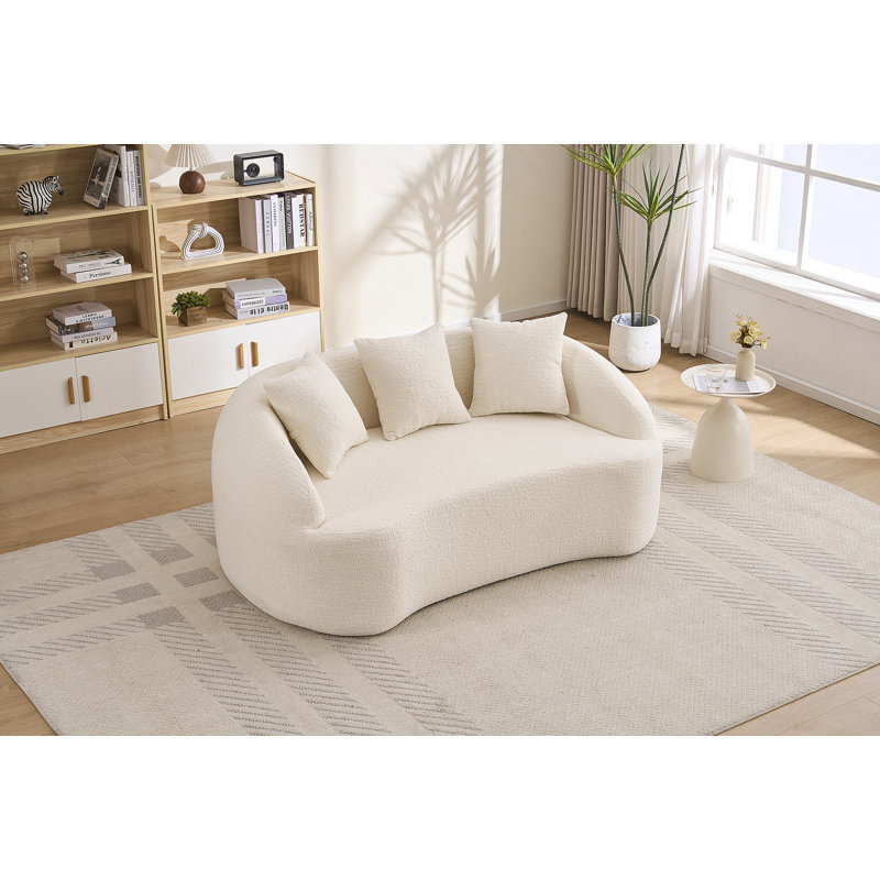 Canapé incurvé moderne sans dossier avec dossier amélioré et revêtement en chenille pour une assise confortable dans des espaces compacts.