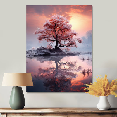 Arbre rose unique au coucher du soleil sur le lac
