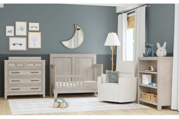 blue toddler boy room with a gray furniture set