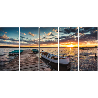 " Boats And Jetty Under Dramatic Sky "