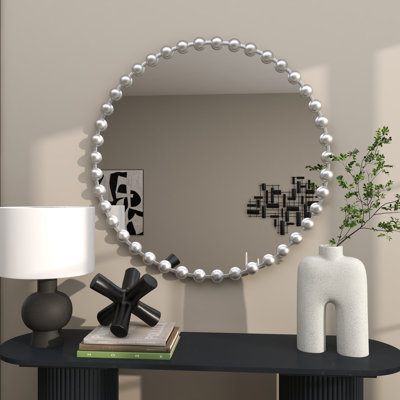 Miroir mural en métal avec détails perlés