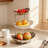 3-Tier Ceramic Fruit Basket With Metal Stand - Elegant Serving Bowl For Fruits, Vegetables, Snacks, Desserts, And Party Display - Sturdy Porcelain Kitchen Storage And Decorative Tray