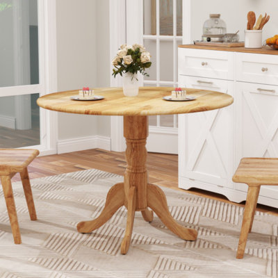 Table de salle à manger en bois avec plateau rond et pieds en tréteaux