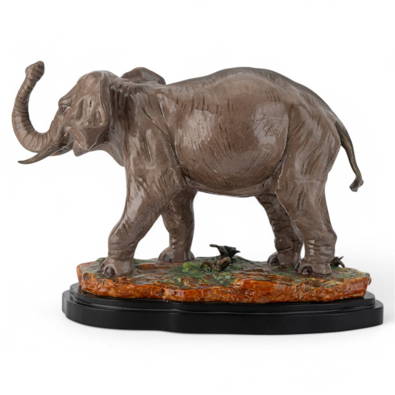 Porcelain Elephant Figurine With Bronze Tusks and Tail Accents On Wood Base