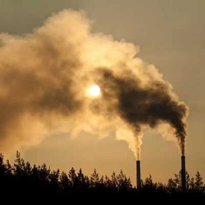 Air Pollution By Smoke Coming Out Of Two Factory Chimneys by HotPhotoPie - Wrapped Canvas Print
