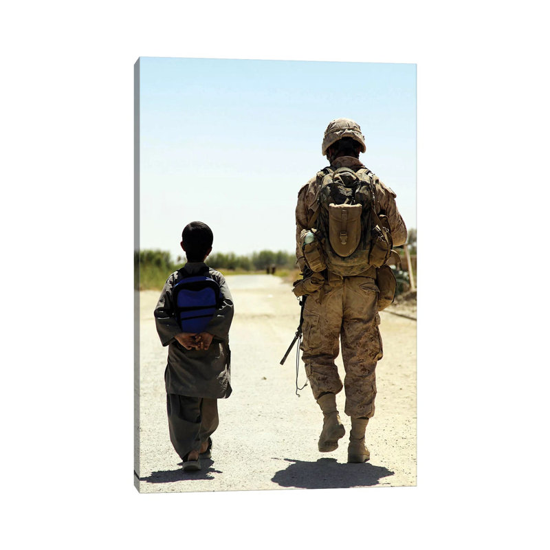 Rear View Of Us Marine Walking Through Nawa Bazaar With An Afghan Boy In Afghanistan by Stocktrek Images - Wrapped Canvas Gallery-Wrapped Canvas Giclée