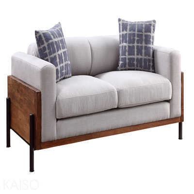 Causeuse en tissu et finition noyer avec 2 coussins décoratifs