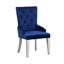 Fauteuil de salle à manger moderne en tissu bleu luxueux avec dossier capitonné et pieds fuselés en bois. Siège rembourré et tablier.