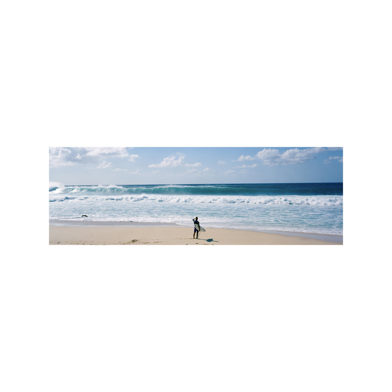 Surfer Standing On The Beach North Shore, Oahu, Hawaii, Usa by Panoramic Images - Wrapped Canvas Panoramic Print