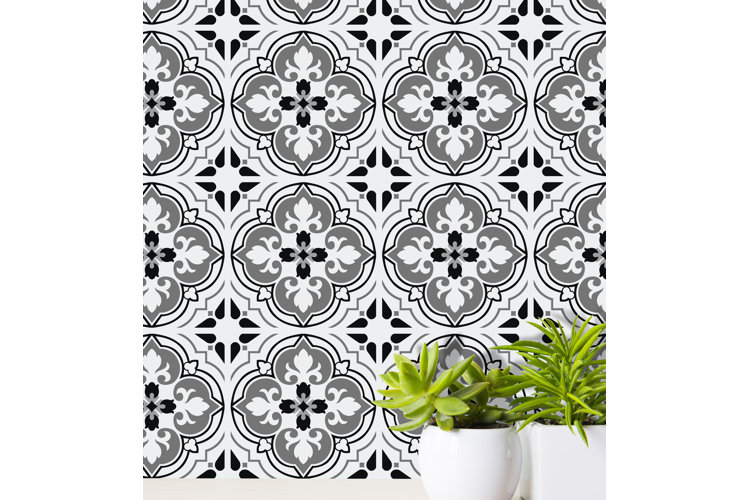 Black and white vinyl peel-and-stick backsplash tile with a Spanish-inspired pattern.