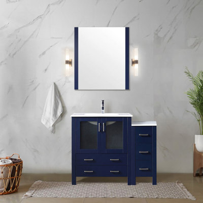 Meuble-lavabo bleu marine simple de 107 cm de large pour salle de bain, comprenant une armoire latérale, une surface en céramique blanche, un robinet, un système de fermeture amortie, 5 tiroirs et 1 armoire. Largeur avec comptoir, robinet inclus.