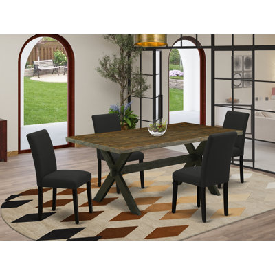 L'ensemble de salle à manger 5 pièces comprend une table de salle à manger rectangulaire avec des pieds en X et 4 chaises Parson rembourrées en tissu de couleur noire, finition noire brossée