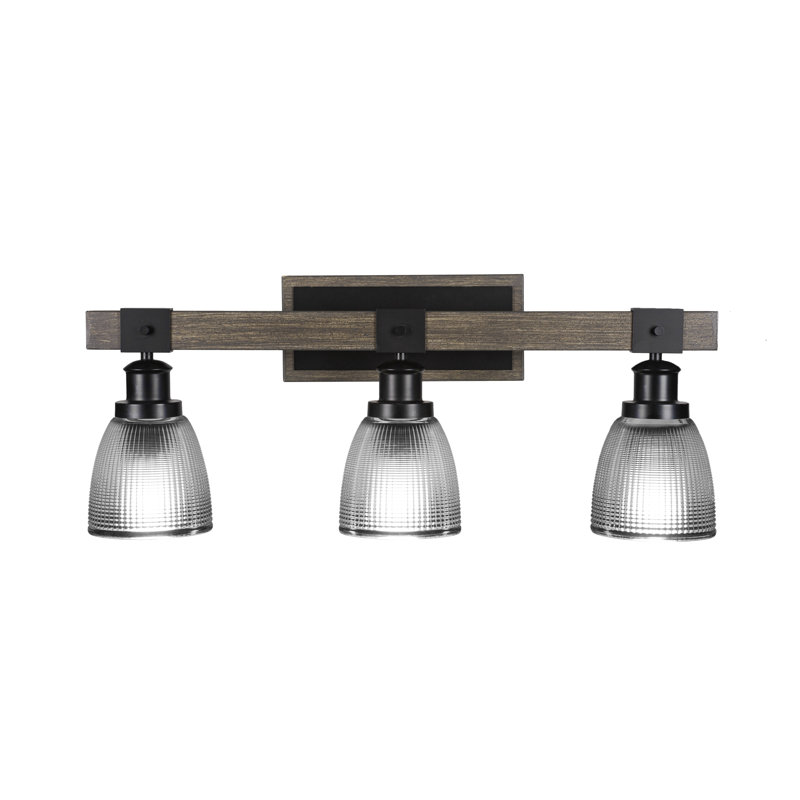 Barre d'éclairage de salle de bain 3 lumières Valera présentée en noir mat et en métal peint d'aspect bois vieilli avec verre côtelé transparent de 5 po