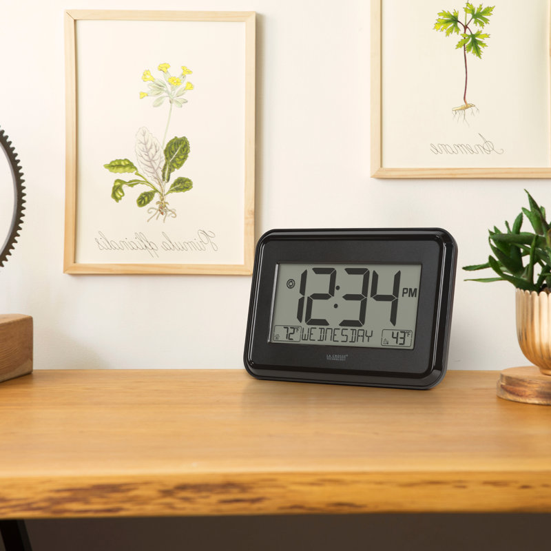 Horloge murale noire avec température intérieure et extérieure