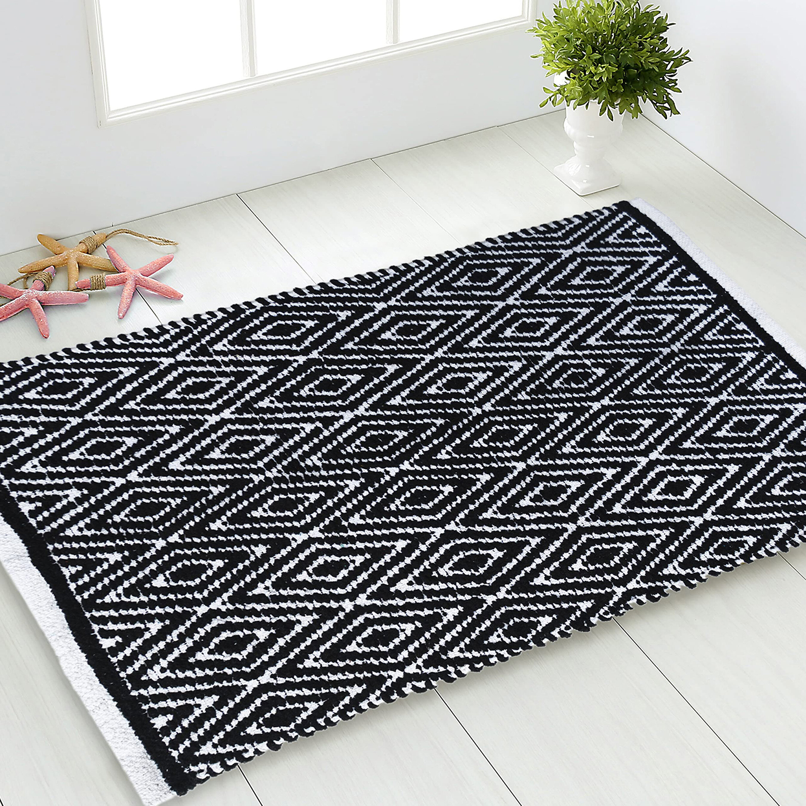 https://assets.wfcdn.com/im/61756412/compr-r85/1922/192226792/siegrist-geometric-hand-woven-flatweave-cotton-black-white-bath-rug.jpg