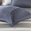 Édredon de chambre à coucher décontracté à rayures avec des draps aux teintes bleues et grises